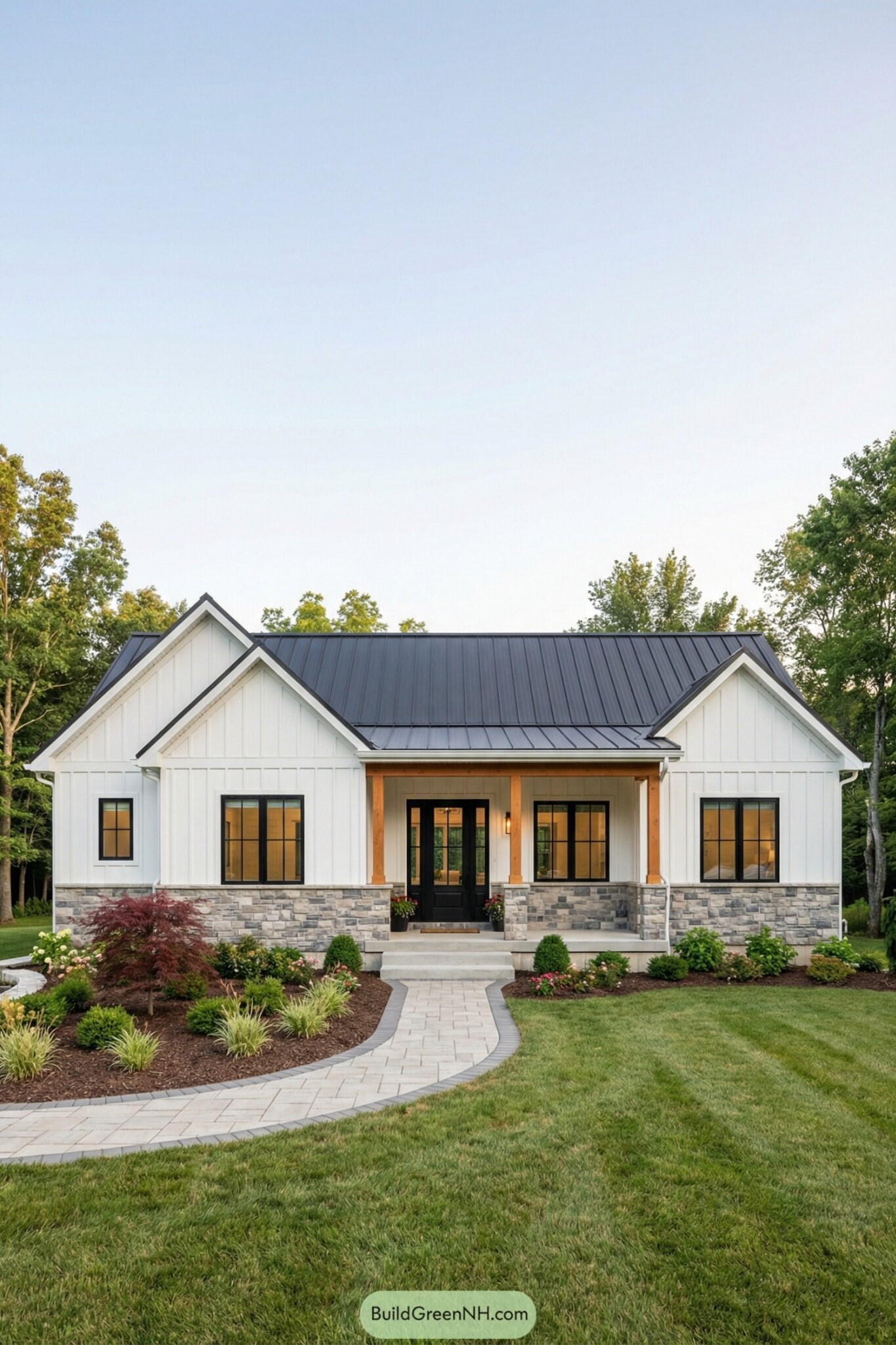A modern white home with a landscaped front yard